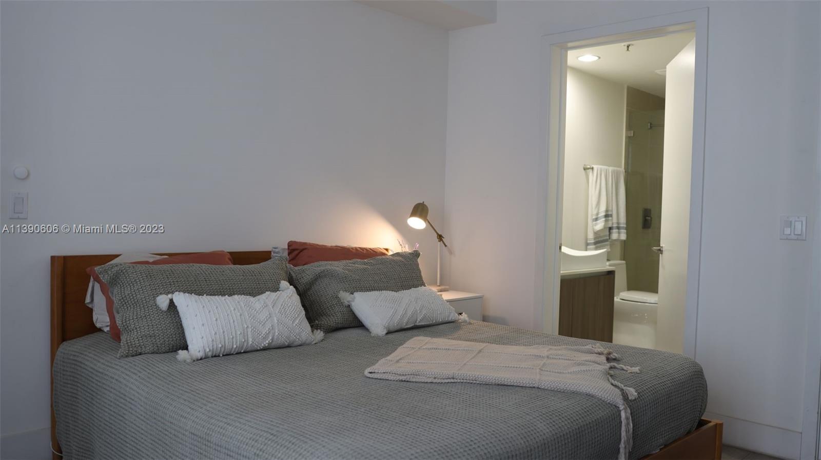 201 Southwest 17th Road, Unit 606 Miami, FL 33129 - Photo 9 of 37 a bed room with a bed and a night stand