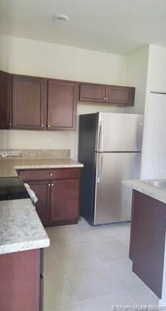 3771 Northeast 1st Street Homestead, FL 33033 - Photo 5 of 7 a kitchen with a refrigerator and a sink
