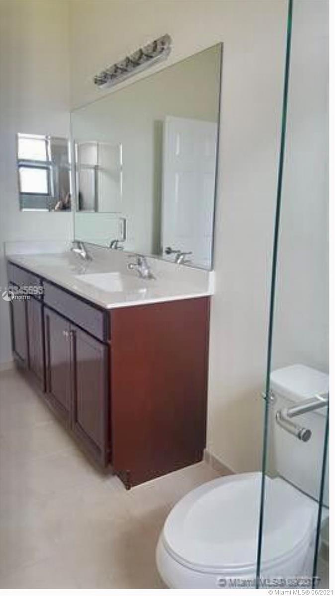 3771 Northeast 1st Street Homestead, FL 33033 - Photo 7 of 7 a bathroom with a sink a toilet and mirror