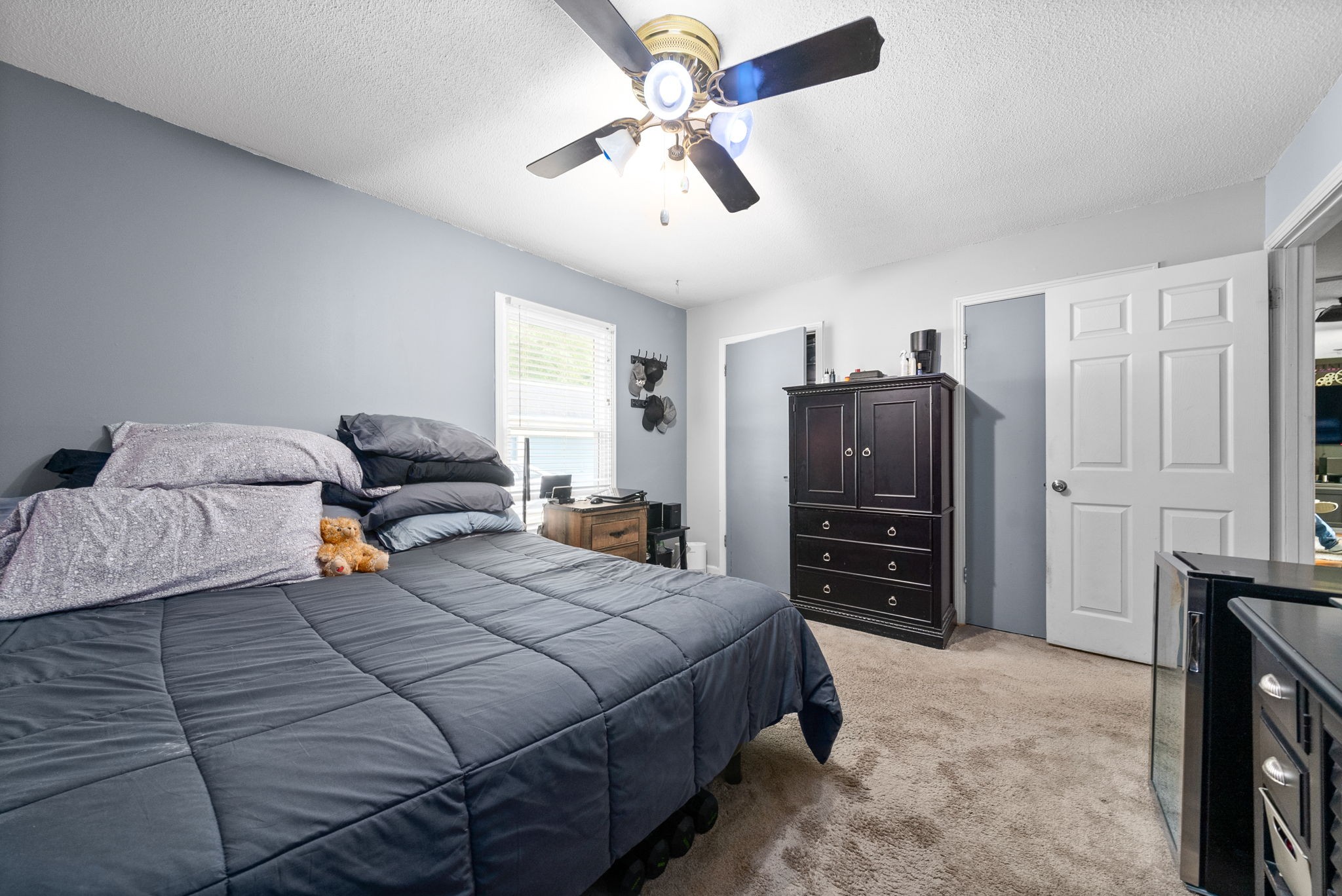 392 Dean Road Clarksville, TN 37040 - Photo 16 of 25 a bedroom with bed a closet and flat tv