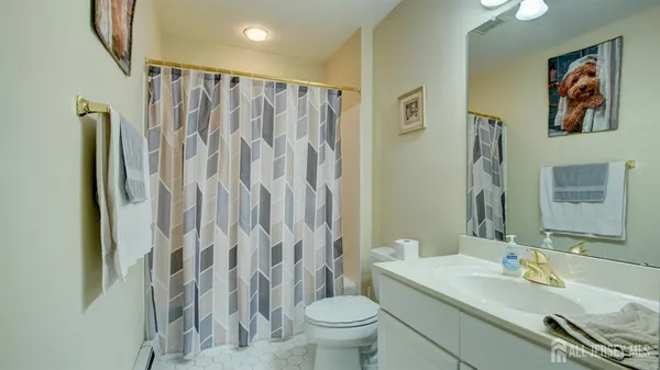a bathroom with a granite countertop sink a toilet and a mirror