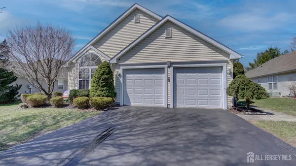 a view of a house with a yard and garage