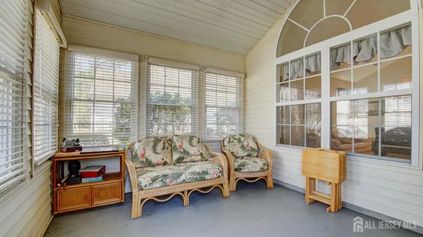 a bedroom with furniture and a window