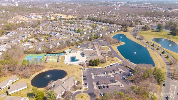 an aerial view of a house with a swimming pool yard and outdoor seating