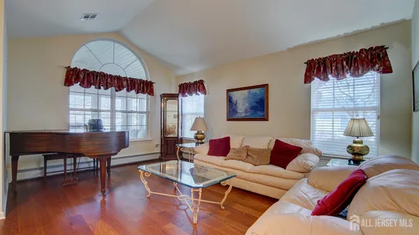 a living room with furniture a window and a flat screen tv