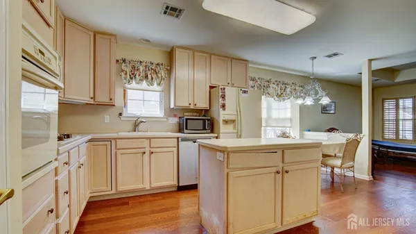a kitchen with white cabinets and sink