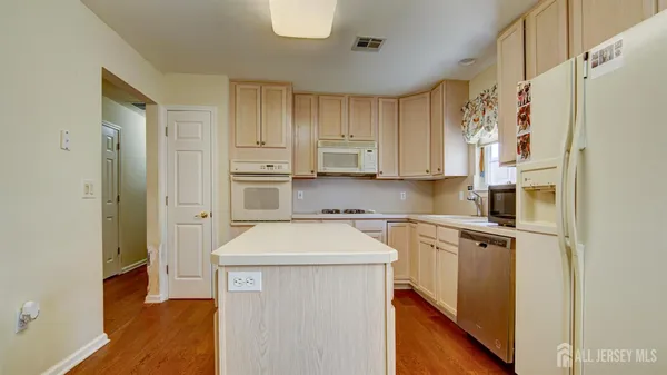 a kitchen with stainless steel appliances a refrigerator sink and cabinets