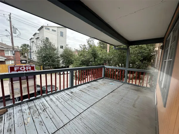 a balcony with wooden floor