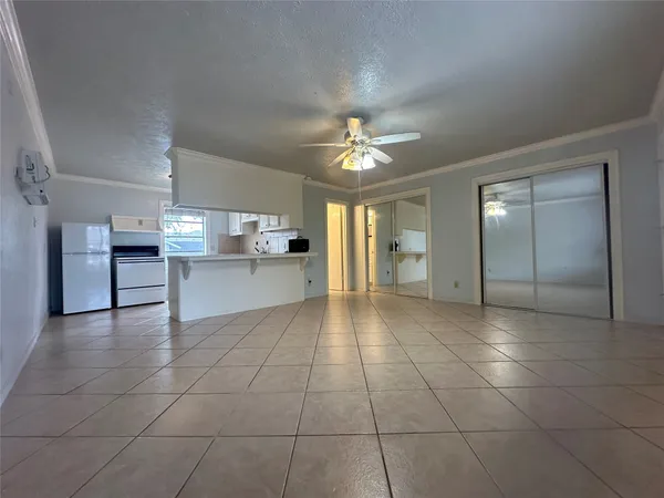 a view of a kitchen with an empty space and window