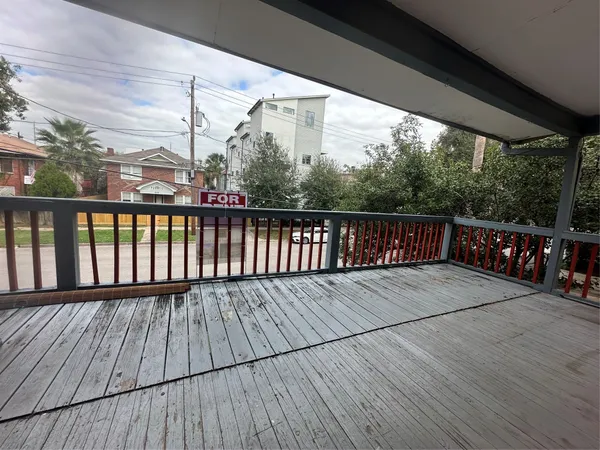 a balcony with wooden floor