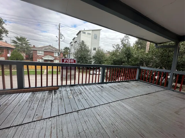 a balcony with wooden floor