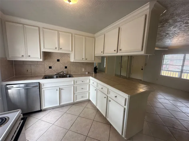 a kitchen with granite countertop white cabinets and white appliances