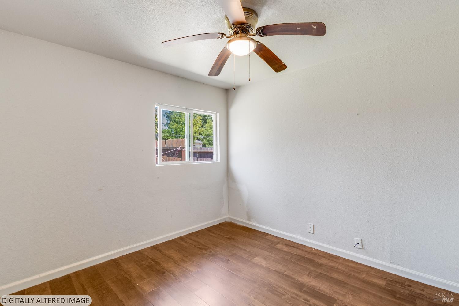 1722 Indiana Street Fairfield, CA 94533 - Photo 7 of 18 an empty room with a window and a ceiling fan