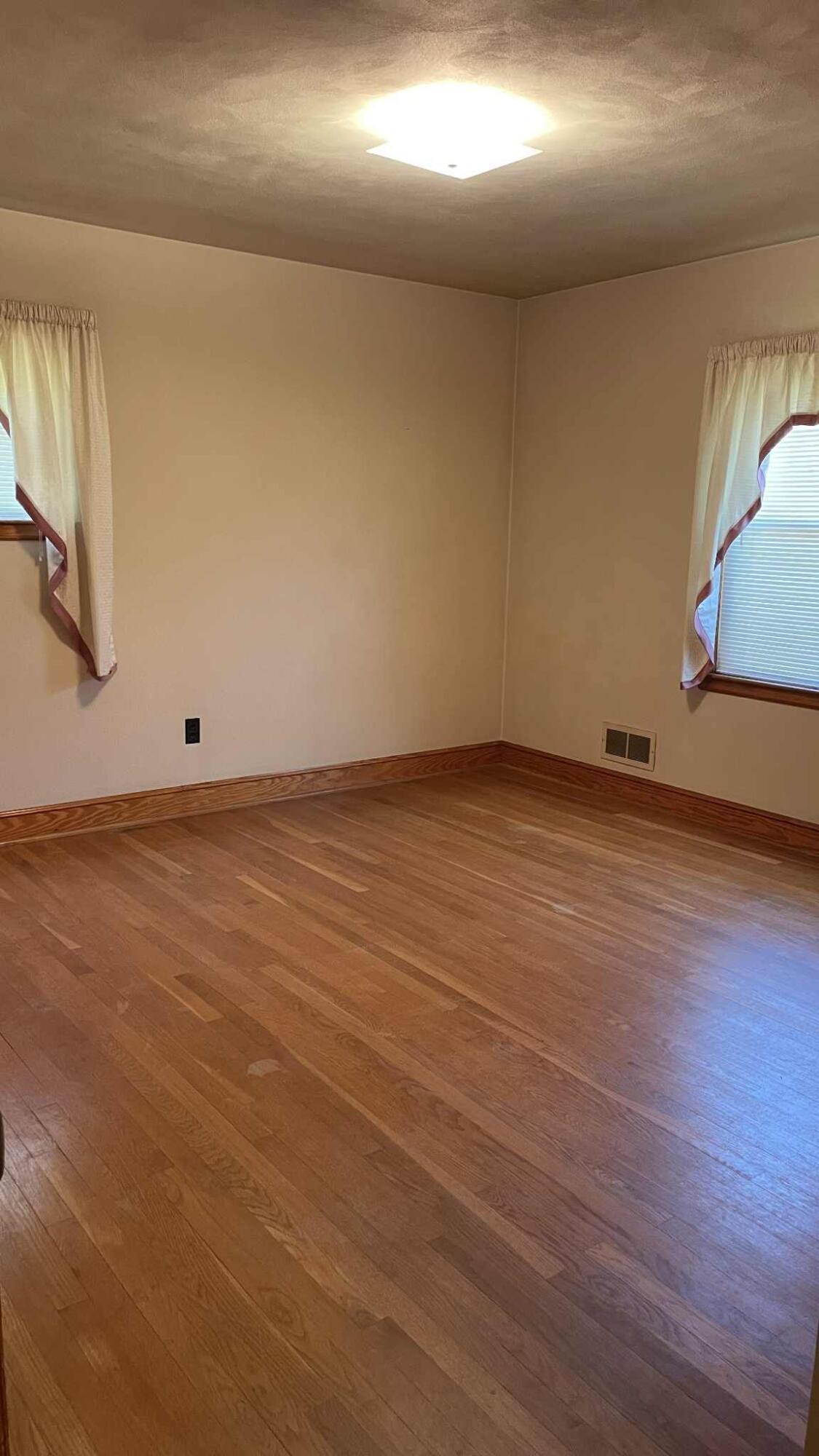 5980 Jordantown Road Vinton, VA 24179 - Photo 3 of 27 an empty room with wooden floor and windows