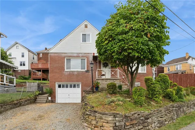 front view of a house with a tree