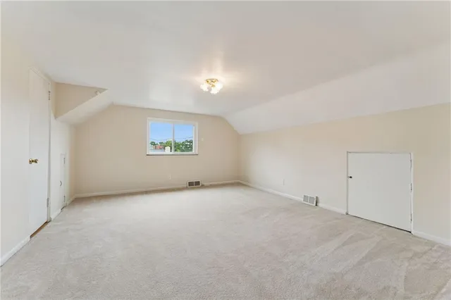 a view of an empty room and a window