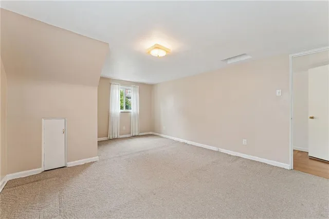 an empty room with windows and entrance