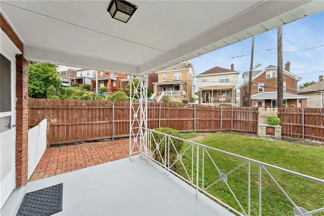 a view of a deck with wooden floor and fence