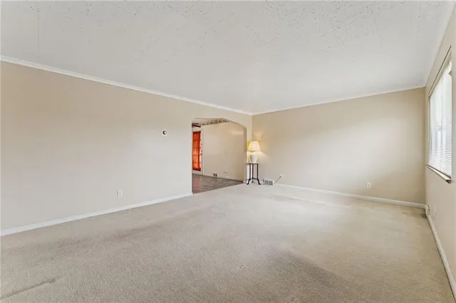 an empty room with a empty space and windows