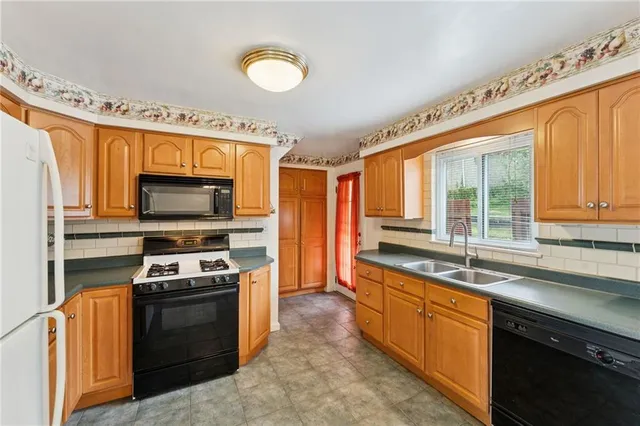 a kitchen with stainless steel appliances a stove sink and microwave