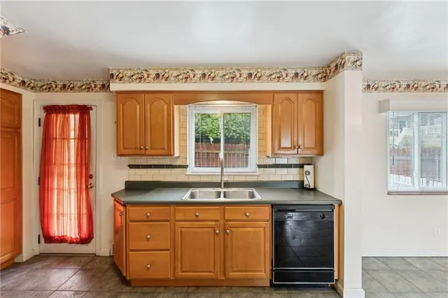 a kitchen with granite countertop a sink and a window