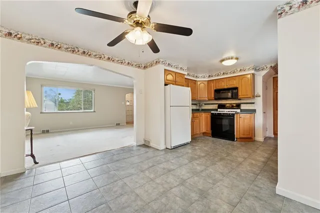 a view of a kitchen with a stove cabinets and stainless steel appliances
