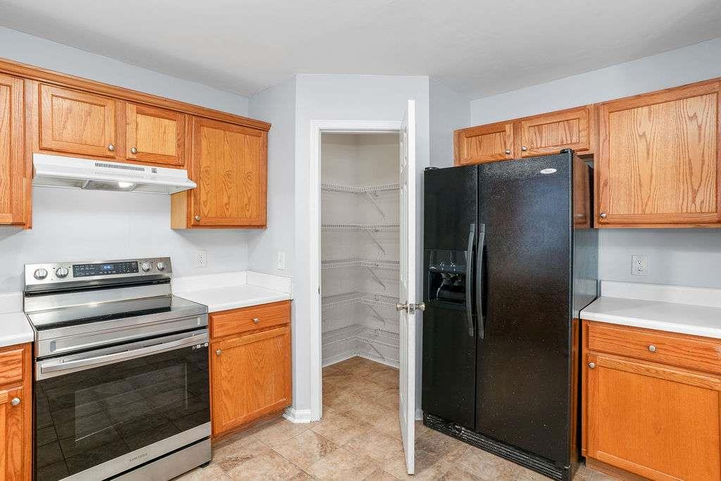 1461 Enchanted Forest Drive Conley, GA 30288 - Photo 13 of 47 a kitchen with stainless steel appliances granite countertop a refrigerator and a stove