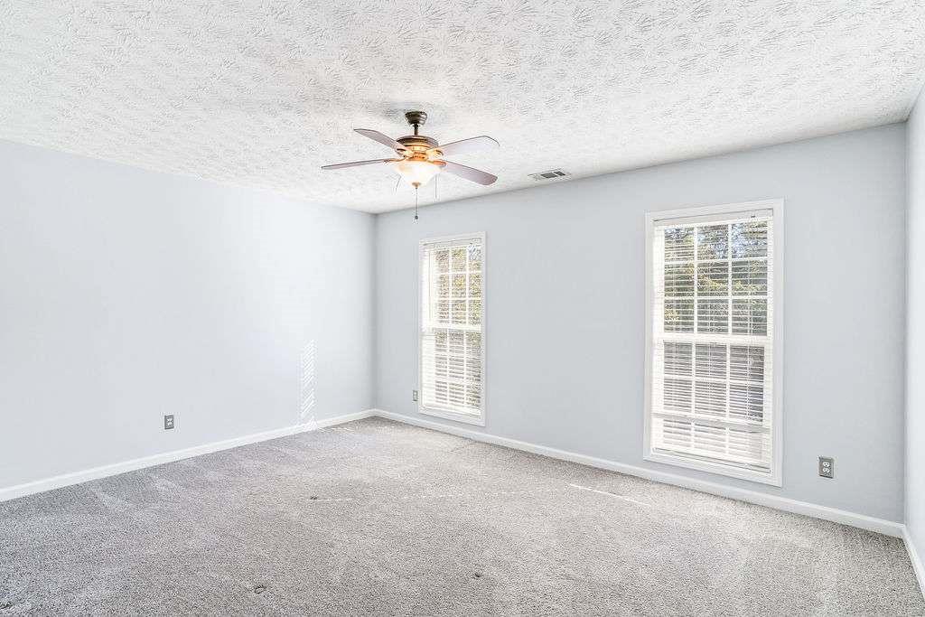1461 Enchanted Forest Drive Conley, GA 30288 - Photo 27 of 47 an empty room with windows and fan