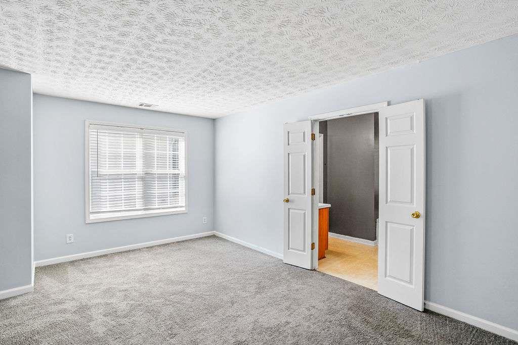 1461 Enchanted Forest Drive Conley, GA 30288 - Photo 29 of 47 an empty room with a window and a bathroom