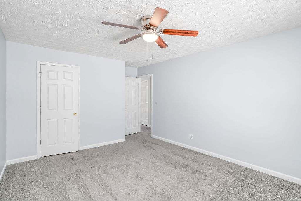 1461 Enchanted Forest Drive Conley, GA 30288 - Photo 39 of 47 an empty room with ceiling fan and window