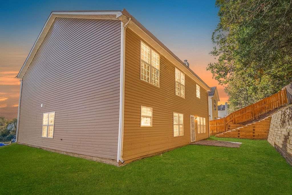 1461 Enchanted Forest Drive Conley, GA 30288 - Photo 45 of 47 a view of a house with a yard