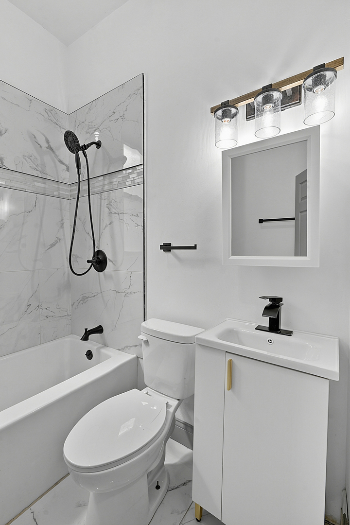 6602 South Marquette Road Chicago, IL 60637 - Photo 8 of 24 a bathroom with a sink a toilet and shower