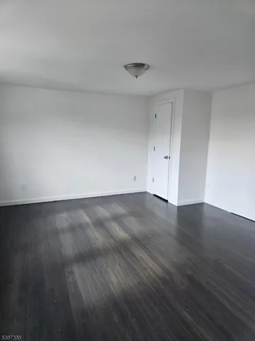 a view of room with wooden floor