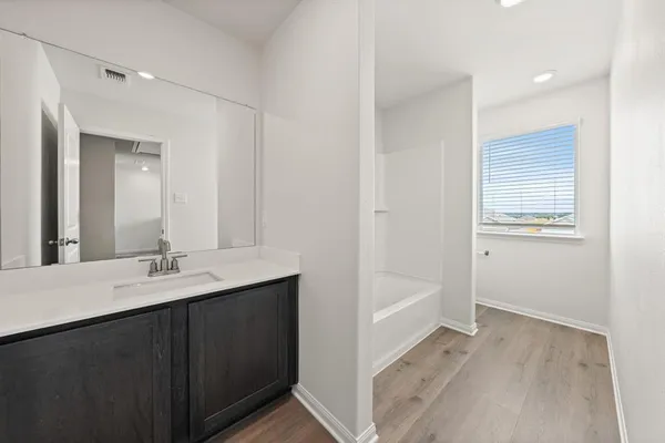 a bathroom with a sink a mirror and a bathtub