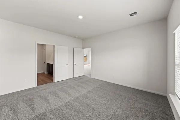 a view of an empty room with a closet