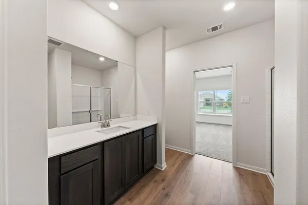 a en suite bathroom with a sink mirror and vanity