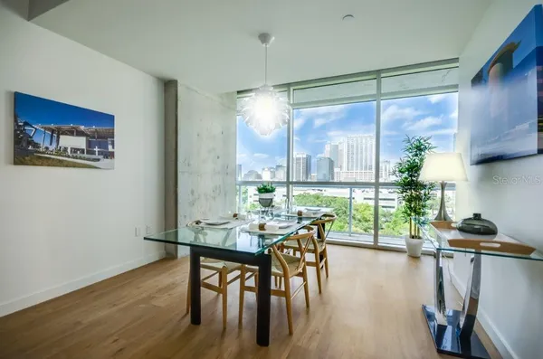 a view of a dining room with furniture window and wooden floor