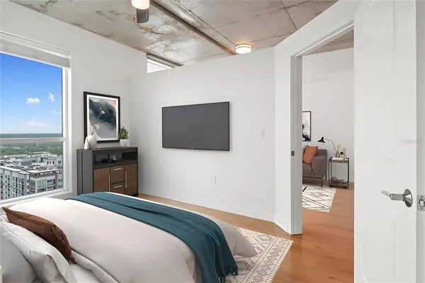 a bedroom with a bed and a television