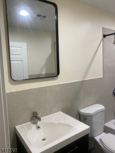 73 Ferry Street Newark, NJ 07105 - Photo 2 of 6 a bathroom with a sink a toilet and mirror