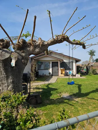 a view of a house with backyard and sitting area