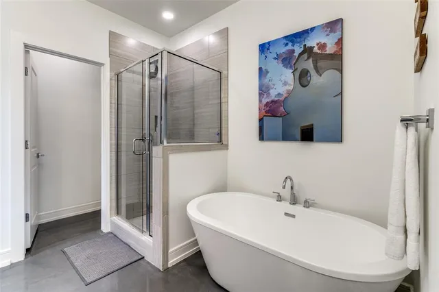 a bathroom with a white bath tub and a shower