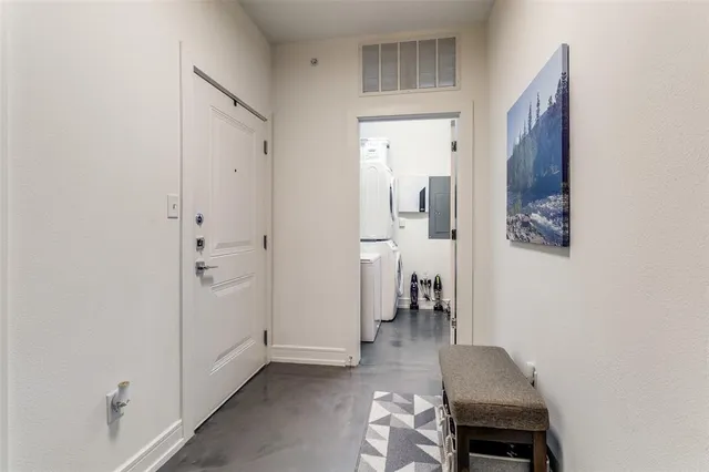 a view of hallway with wooden floor and furniture