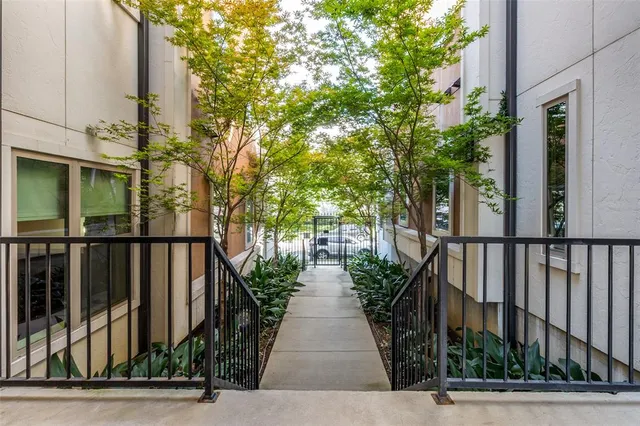 a view of a pathway both side of house with yard