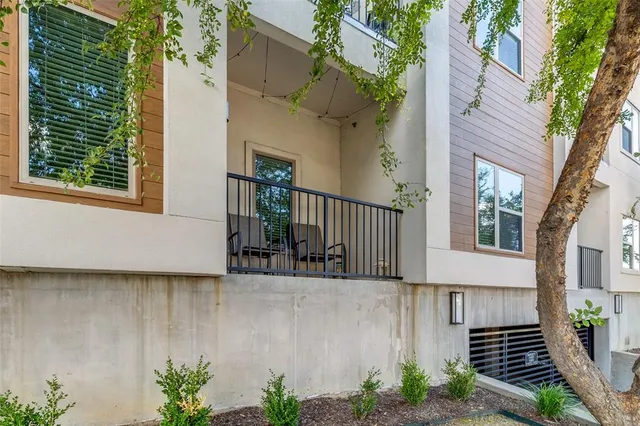 a view of a house with a small yard and wooden floor and fence