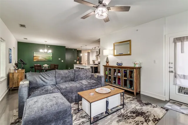 a living room with furniture and a dining table