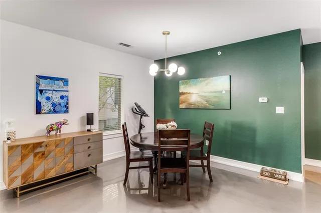 a view of a dining room with furniture and chandelier