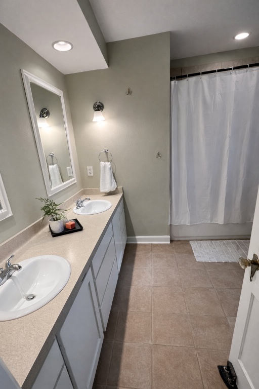305 West Davilla Street Granger, TX 76530 - Photo 11 of 20 a bathroom with double vanity sink and a mirror