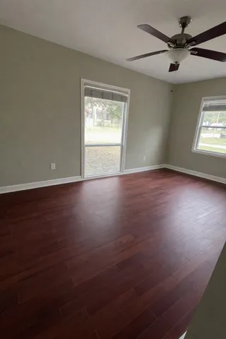 a bedroom with a bed window and dresser