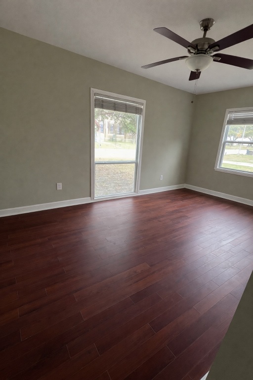 305 West Davilla Street Granger, TX 76530 - Photo 14 of 20 a view of an empty room with a window and wooden floor