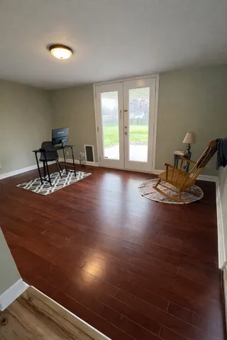 a kitchen view with wooden floor and electronic appliances